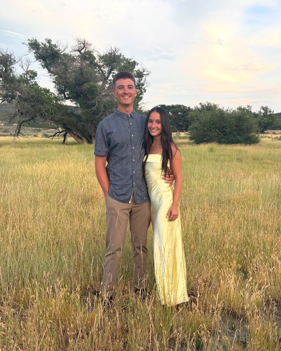 Zane Cannon, owner of Cannon Landscape, with his fiancée in a grassy field at golden hour